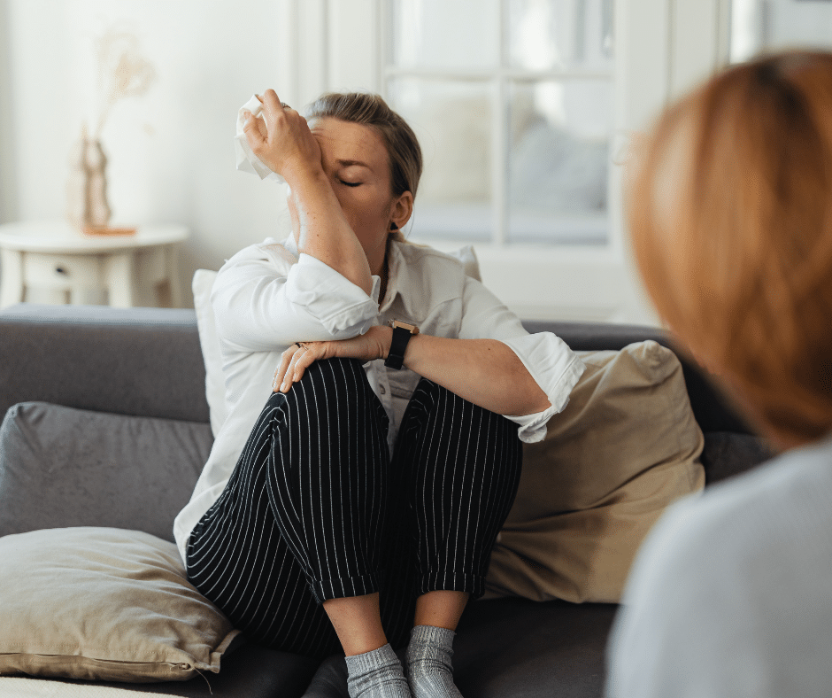 mujer llorando en el sofá